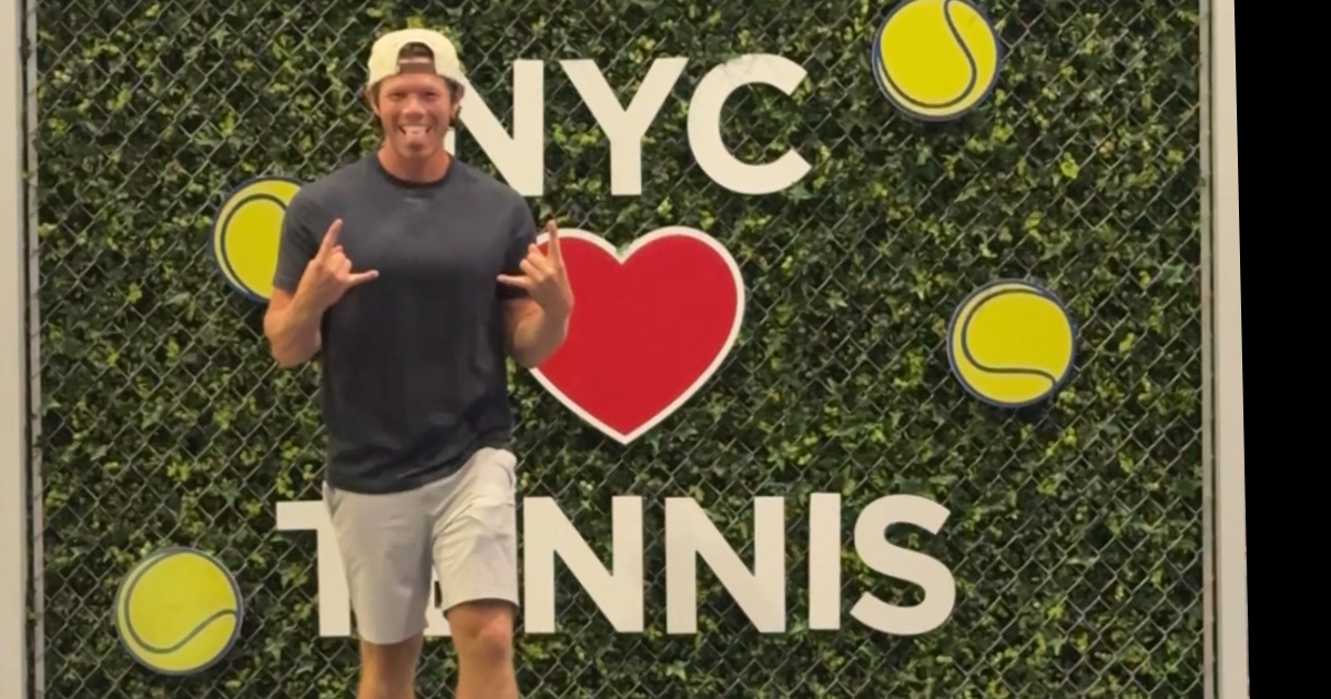 Enjoying my desire of loving tennis in front of an "NYC loves tennis" sign
